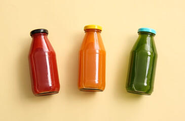 Bottles with healthy juice on color background