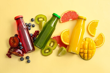 Bottles with healthy juice and fruits on color background