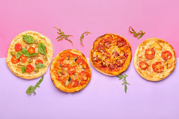 Tasty mini pizzas on color background