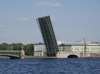 Naklejka premium A Trinity Bridge drawbridge across the Neva River in St. Petersburg on a sunny summer day. A drawbridge connecting Vasilyevsky Island and the central part of the city. 