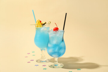 Glasses of Blue Lagoon cocktail on color background