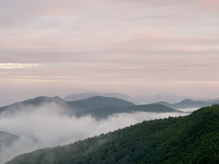 a beautiful view of mountains with clouds at dawn