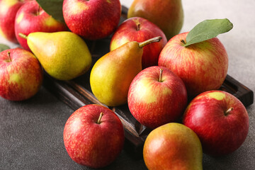 Board with ripe fruits on table, closeup