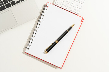 Flat lay, top view office white wooden table desk. Workspace with blank clip board, keyboard, office supplies,laptop,Notebook,pen,copy space on white background.