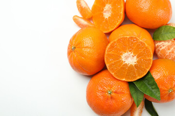 Mandarin pile with leaves on white background