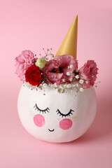 Сute pumpkin with halloween makeup on pink background