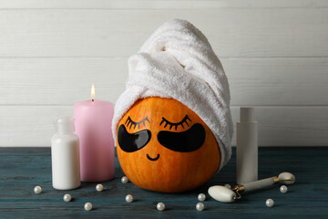 Spa concept with pumpkin on wooden background