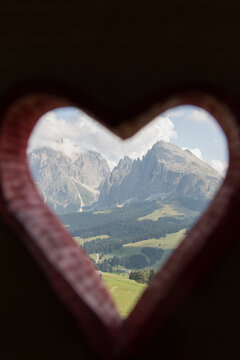 August 21, 2021: top of Sassopiatto and Sassolungo of the Dolomites framed by a red heart, Italy