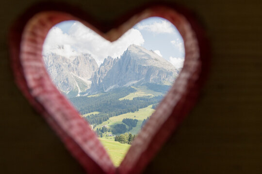 August 21, 2021: top of Sassopiatto and Sassolungo of the Dolomites framed by a red heart, Italy