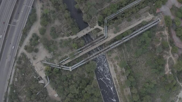 An aerial shot of water flowing by at Karnal Bypass in New Delhi, India
