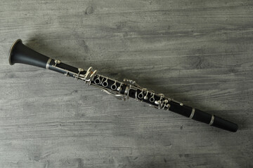 Clarinet on gray textured table, top view