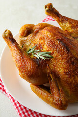 Plate with roast turkey on white textured table