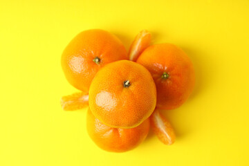 Tasty fresh mandarins on yellow background, top view