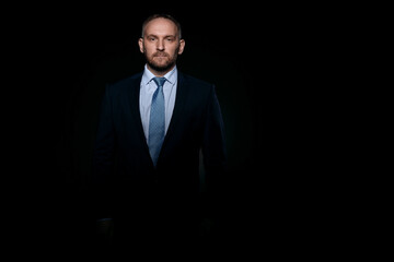 Man in a business suit on a black background
