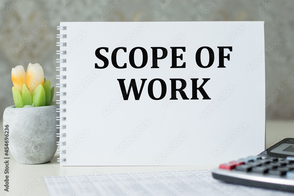 Poster scope of work inscription on a notepad on the table. business conept