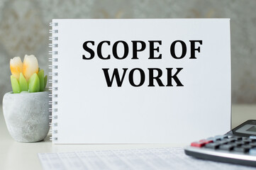 Scope of work inscription on a notepad on the table. BUSINESS CONEPT