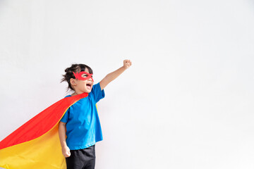 Funny little girl playing power super hero over white background. Superhero concept.