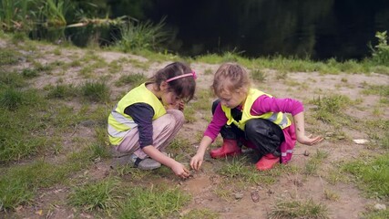 forest kindergarten. Happy Preschool group of children play in the swamp in park or forest. Outdoors small child have fun playing with mud in a woods. Hike. Summer Camp curious, leisure in nature