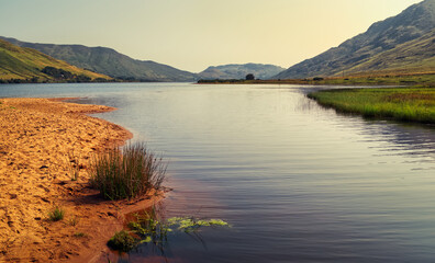 Beautiful landscape scenery of sandy beach and mountains in the background at Loch na fooey in connemara, county Galway, Ireland 