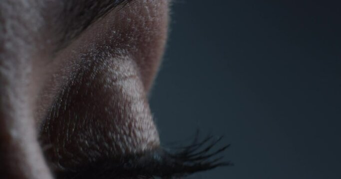 close up macro eye applying makeup mascara with brush beauty cosmetics concept