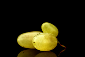 Several berries of ripe sweet grapes, close-up, isolated on black.