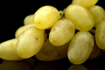 A bunch of ripe sweet grapes, close-up, isolated on black.