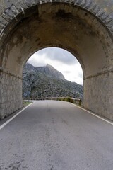 Fototapeta na wymiar The road through the tunnel, with a mountain in the background