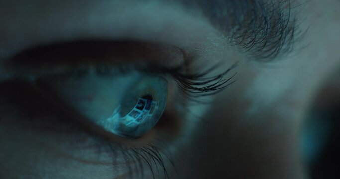 macro eye looking at tablet screen browsing social media at night addiction concept