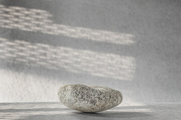 Stone pedestal of free space for your decoration and wall with shadows. Free space for your product. 
