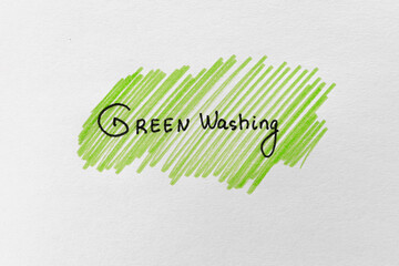 Greenwashing concept. Drawing on paper with text and green marker strokes. Environmental marketing disinformation. Non transparent green sheen.