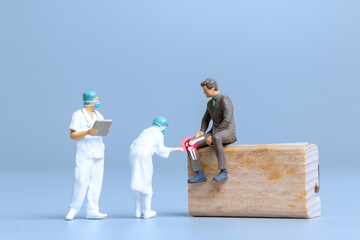 Miniature people Doctors treat rheumatism, osteoarthritis , World arthritis day concept