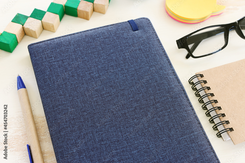 Fototapete top view image of open notebook with blank pages on wooden table. ready for adding text or mockup