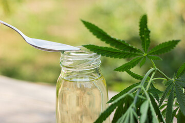 hemp oil in a glass jar with hemp leaf, hemp extracts, health.