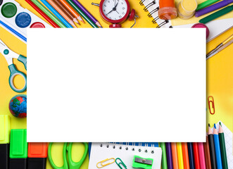 School banner with alarm clock, paint, pencils and scissors. School accessories on a yellow background. Flat lay style, view from above. Empty space
