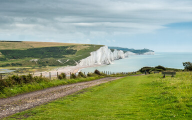 Sussex Coast, England. The cliffs of East Sussex looking over Cuckmere Haven and the Seven Sisters white chalk cliffs into the English Channel. - 454705669