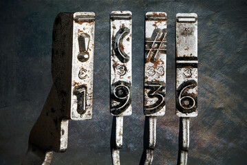 vintage old typewriter hammers with the date 1936  isolated