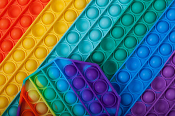 POP IT toys, funny educational children's toys and hand simulators, close-up. Selective focus, copy space