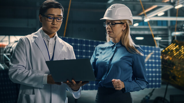 Engineer and Technician Working on Satellite Construction. Aerospace Agency: Diverse Team of Scientists Using Technological Equipment and Laptop Computer to Develop Spacecraft for Space Exploration.
