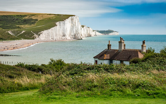 Fisherman's Cottages, England. The rugged coast of East Sussex looking over the Seven Sisters white chalk cliffs into the English Channel. - Powered by Adobe