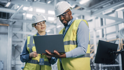 Team of Diverse Professional Heavy Industry Engineers Wearing Safety Uniform and Hard Hats Working...