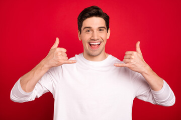 Photo portrait brunet guy in white shirt laughing asking to call him isolated vivid red color...