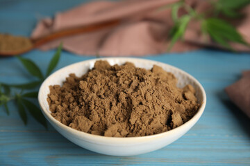 Hemp protein powder on light blue wooden table, closeup