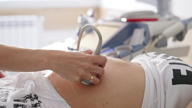 Obstetrician examining pregnant belly by ultrasound scan. Process of fetal ultrasonography. Pregnancy and Healthcare concept.