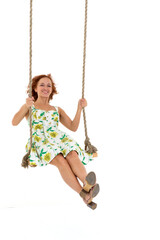 Beautiful young woman swinging on rope swing