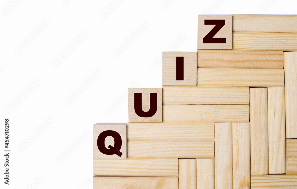 Poster on a light background, wooden blocks and cubes with the text quiz