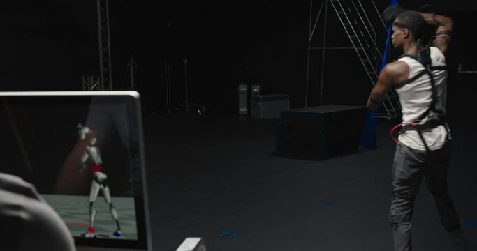 mocap man wearing motion capture suit in studio performing  bo staff sword fighting martial arts actor wearing mo-cap suit for 3d character animation for virtual reality gaming industry