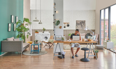 Man is working beautiful home, he is living alone and there are two different division at home, washing machine working table together.