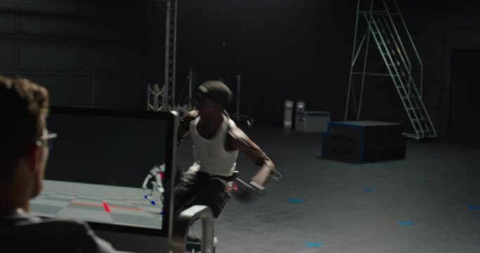 fit man wearing motion capture suit in studio fighting computer gaming martial arts actor boxing wearing mo-cap suit for 3d character animation for virtual reality fighting game