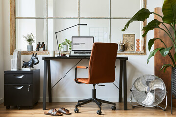 Creative composition of modern masculine home office workspace interior with black industrial desk, brown leather armchair, laptop and stylish personal accessories. Template.