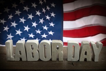 Happy Labor Day banner. USA flag and letters on rustic wooden background.